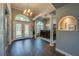 Elegant foyer with wood floors, arched doorways, and a chandelier at 6071 Sabal Hammock Cir, Port Orange, FL 32128