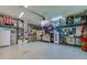 Organized garage with storage solutions, workspace, and a large refrigerator at 6071 Sabal Hammock Cir, Port Orange, FL 32128