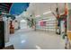 Spacious garage with a clean white floor and an American flag on the garage door at 6071 Sabal Hammock Cir, Port Orange, FL 32128