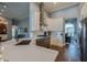 Bright kitchen features white cabinets, a stainless steel hood, and views into living and dining areas at 6071 Sabal Hammock Cir, Port Orange, FL 32128