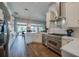 Open kitchen showcasing stainless steel appliances and white cabinets with seamless connection to the living area at 6071 Sabal Hammock Cir, Port Orange, FL 32128
