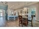 Bright kitchen and dining area featuring white cabinetry, a breakfast bar, and a wooden dining set at 6071 Sabal Hammock Cir, Port Orange, FL 32128