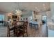 Open-concept kitchen and dining area, featuring white cabinets, breakfast bar, and a dining table at 6071 Sabal Hammock Cir, Port Orange, FL 32128
