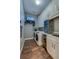 Well-equipped laundry room with washer, dryer, sink, wine fridge and ample storage cabinets at 6071 Sabal Hammock Cir, Port Orange, FL 32128