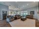 Large living room features a neutral rug, comfortable couches, and a ceiling fan, blending with the kitchen at 6071 Sabal Hammock Cir, Port Orange, FL 32128