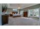 Spacious primary bedroom boasts tray ceiling, large windows and natural light with neutral carpet at 6071 Sabal Hammock Cir, Port Orange, FL 32128