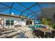 The screened patio features a pool, lounge chairs, and outdoor dining area at 6071 Sabal Hammock Cir, Port Orange, FL 32128