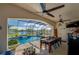Enclosed patio features a dining table and chairs, with pool and lake views at 6071 Sabal Hammock Cir, Port Orange, FL 32128