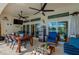 Covered patio with ceiling fans, a dining table, and a view of the lake at 6071 Sabal Hammock Cir, Port Orange, FL 32128