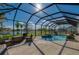 Tranquil screened pool area with lush landscaping and beautiful lake view at 6071 Sabal Hammock Cir, Port Orange, FL 32128