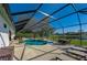 Spacious screened patio with a pool, lake view, and outdoor furniture at 6071 Sabal Hammock Cir, Port Orange, FL 32128