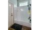 Bathroom shower with a glass enclosure and white tile, next to a door at 6071 Sabal Hammock Cir, Port Orange, FL 32128