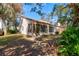 Backyard features a partial lawn, mature trees, and lush landscaping around the perimeter of the house at 6152 Sequoia Dr, Port Orange, FL 32127