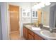 Clean bathroom with double sinks, wooden cabinets, and a tiled shower stall at 6152 Sequoia Dr, Port Orange, FL 32127