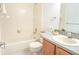 Bathroom featuring a tiled shower and tub, a vanity sink with a decoratively tiled countertop at 6152 Sequoia Dr, Port Orange, FL 32127