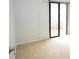 Bedroom with a private balcony featuring black framed sliding doors and neutral carpeting at 6152 Sequoia Dr, Port Orange, FL 32127