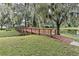 Wooden community bridge in a tranquil setting, enhancing the neighborhood's charm and providing scenic views at 6152 Sequoia Dr, Port Orange, FL 32127
