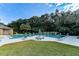 Community pool surrounded by lush greenery, providing a refreshing oasis for relaxation and recreation at 6152 Sequoia Dr, Port Orange, FL 32127