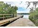 Scenic wooden dock overlooking tranquil lake waters with lush greenery, perfect for enjoying nature at 6152 Sequoia Dr, Port Orange, FL 32127