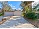 View of the exterior showcasing the property's two-car garage, landscaping, and well-maintained driveway at 6152 Sequoia Dr, Port Orange, FL 32127