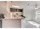 Eat-in kitchen features white cabinets, tiled flooring, breakfast bar, and ample natural light from the adjacent dining area at 6152 Sequoia Dr, Port Orange, FL 32127