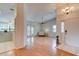 Open-concept living room with wood floors, a ceiling fan, and French doors to the outdoor space at 6152 Sequoia Dr, Port Orange, FL 32127