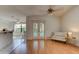 Light-filled living room with access to the pool via glass doors, complemented by neutral decor and wood flooring at 6152 Sequoia Dr, Port Orange, FL 32127