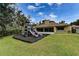 Community playground on a grassy lawn next to a building providing a safe and fun environment for children to play at 6152 Sequoia Dr, Port Orange, FL 32127