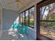 Bright sunroom with tiled floors and surrounded by large windows with views of lush greenery at 6152 Sequoia Dr, Port Orange, FL 32127
