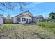 Backyard of home with a small wooden deck and lawn at 6157 Sequoia Dr, Port Orange, FL 32127