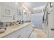Bright bathroom with double vanity, neutral countertops, and tiled shower at 6157 Sequoia Dr, Port Orange, FL 32127