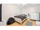 Well-lit bedroom with a comfortable bed, dresser, and beanbag chair at 6157 Sequoia Dr, Port Orange, FL 32127