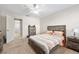 Inviting bedroom with bed, a ceiling fan, and connecting bathroom at 6157 Sequoia Dr, Port Orange, FL 32127