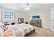 Comfortable bedroom with a ceiling fan, window views, and dresser storage at 6157 Sequoia Dr, Port Orange, FL 32127