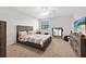 Cozy bedroom with a comfortable bed, ceiling fan, and dresser storage at 6157 Sequoia Dr, Port Orange, FL 32127