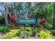 Greenbriar, a deed-restricted community, has a beautifully landscaped entrance with vibrant plants and mature trees at 6157 Sequoia Dr, Port Orange, FL 32127
