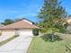 Charming home featuring a two-car garage, well-maintained lawn, and lovely curb appeal at 6157 Sequoia Dr, Port Orange, FL 32127