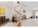 Open living room with a spiral staircase, tile floors, and natural light at 6157 Sequoia Dr, Port Orange, FL 32127
