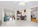 Open living room with tile floors, an office area, and open access to other rooms at 6157 Sequoia Dr, Port Orange, FL 32127