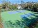 Community amenities including two tennis courts, surrounded by mature trees at 6157 Sequoia Dr, Port Orange, FL 32127