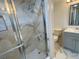 Beautifully renovated bathroom featuring glass shower, marble style floor and vanity with granite counter at 625 N Halifax Ave # 15, Daytona Beach, FL 32118