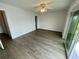 This bright bedroom features wood floors and a sliding glass door leading to the balcony at 625 N Halifax Ave # 15, Daytona Beach, FL 32118