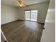 Bright bedroom features wood floors, ceiling fan and sliding doors to a balcony with a water view at 625 N Halifax Ave # 15, Daytona Beach, FL 32118