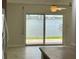 Bright living room with fan and sliding glass doors to balcony with water views at 625 N Halifax Ave # 15, Daytona Beach, FL 32118