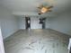Open-concept living room with tile flooring leading to kitchen and entryway at 625 N Halifax Ave # 15, Daytona Beach, FL 32118
