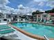 A beautiful community pool is surrounded by deck chairs and townhouses at 625 N Halifax Ave # 15, Daytona Beach, FL 32118