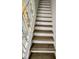 Wooden staircase with white trim and wrought iron banister at 625 N Halifax Ave # 15, Daytona Beach, FL 32118