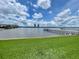 Expansive water view featuring a pier, bridge, and two buildings in the distance under a cloudy sky at 625 N Halifax Ave # 15, Daytona Beach, FL 32118