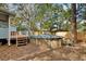 Backyard featuring an above ground pool with wooden deck and mature trees at 749 E Wisconsin Ave, Orange City, FL 32763