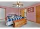 Comfortable bedroom featuring plush carpet, ceiling fan and bathroom access at 749 E Wisconsin Ave, Orange City, FL 32763